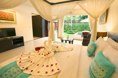 twoomorphicomorphic swans on a table in a living room at Lavender 1 BR Private Pool Villa in Seminyak