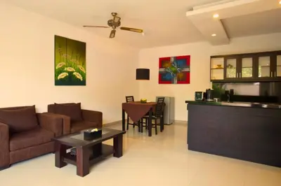 a living room with a couch and a table at Lavender 1 BR Private Pool Villa in Seminyak