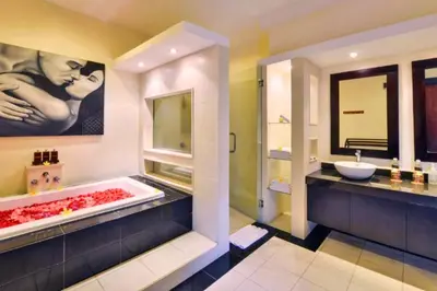 a bathroom with a bath tub and a sink at Lavender 1 BR Private Pool Villa in Seminyak