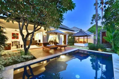 a swimming pool in front of a house at Lavender 1 BR Private Pool Villa in Seminyak
