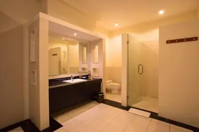 a bathroom with a toilet and a sink and a shower at Ageratum 4 BR Villa Private Pool in Seminyak