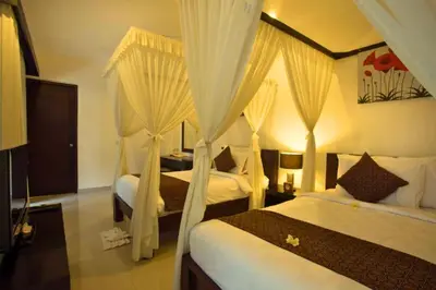 a bedroom with two beds with drapes at Ageratum 4 BR Villa Private Pool in Seminyak