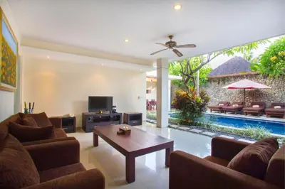 a living room with a couch and a table at Ageratum 4 BR Villa Private Pool in Seminyak