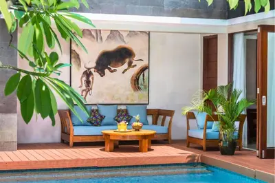 a living room with a blue couch and a table at Luxury 3 BR Private Pool Villa in Seminyak