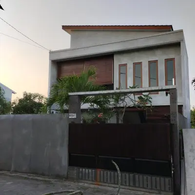 a house with a fence in front of it at Jimbaran Beauteous Villa in Jimbaran