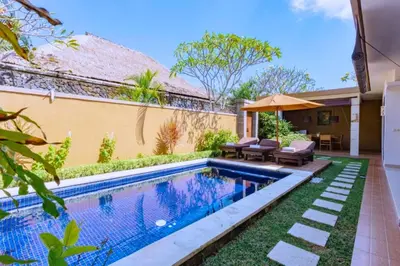 a swimming pool in the backyard of a house at Dahlia Mentari 2 BR Private Pool Villa in Seminyak