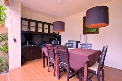 a kitchen and dining room with a table and chairs at Dahlia Mentari 2 BR Private Pool Villa in Seminyak