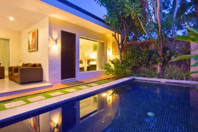 a house with a swimming pool and a living room at Dahlia Mentari 2 BR Private Pool Villa in Seminyak