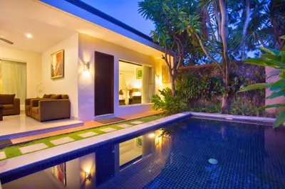 a swimming pool in a house with a living room at Allamanda 3 BR Private Pool Villa in Seminyak