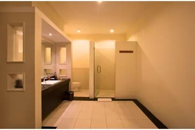 a bathroom with a shower and a sink at Allamanda 3 BR Private Pool Villa in Seminyak