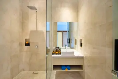 a bathroom with a sink and a shower with a mirror at Modern 3 BR Private Pool Villa in Legian