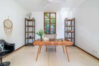 a room with a wooden table and a chair at Villa Ayuni, Berawa in Canggu