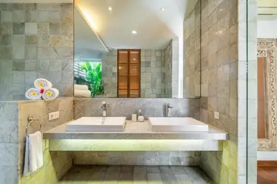 a bathroom with two sinks and a large mirror at Villa Ayuni, Berawa in Canggu