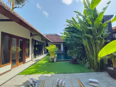a courtyard of a villa with a swimming pool at Villa JES - 4 Bedroom Villa - Legian in Legian