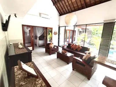 a living room with couches and chairs in a house at Villa JES - 4 Bedroom Villa - Legian in Legian
