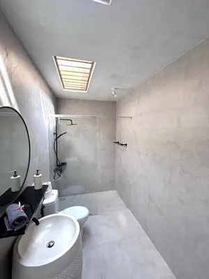a bathroom with a sink and a toilet and a mirror at Villa JES - 4 Bedroom Villa - Legian in Legian