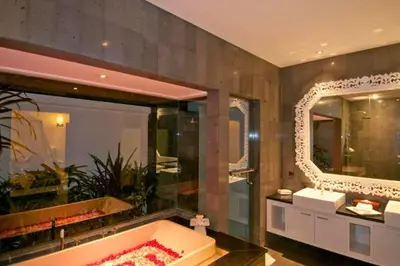 a bathroom with a tub and a large mirror at Cozy 2 BR Private Pool Villa in Seminyak