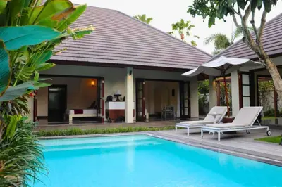 a villa with a swimming pool and a house at Cozy 2 BR Private Pool Villa in Seminyak