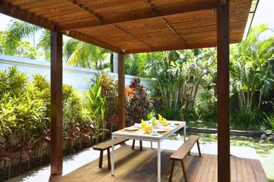 a white table and chairs on a wooden deck at Cozy 2 BR Private Pool Villa in Seminyak