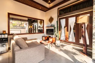 a living room with a couch and a table at Cosy Traditional and Fresh 2 BD Sunterrace Villa with Pvt Pool in Kerobokan