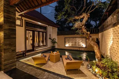 a backyard with a pool and a table and chairs at Cosy Traditional and Fresh 2 BD Sunterrace Villa with Pvt Pool in Kerobokan