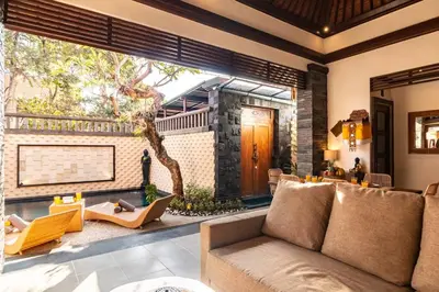 a living room with a couch and a large window at Cosy Traditional and Fresh 2 BD Sunterrace Villa with Pvt Pool in Kerobokan