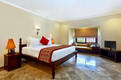 a hotel room with a bed and a television at Entire 2 BR Private Pool Villa in Seminyak