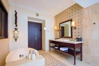 a bathroom with a tub and a sink and a mirror at Entire 2 BR Private Pool Villa in Seminyak
