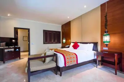 a bedroom with a bed and a desk and a chair at Entire 2 BR Private Pool Villa in Seminyak