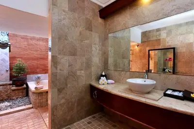 a bathroom with a sink and a mirror and a tub at Entire 2 BR Private Pool Villa in Seminyak