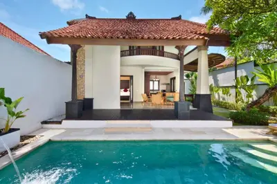 a swimming pool in front of a house with a gazebo at Entire 2 BR Private Pool Villa in Seminyak