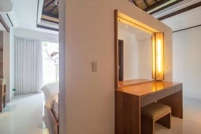 a bedroom with a dressing table and a mirror at Rekso Villa in Jimbaran