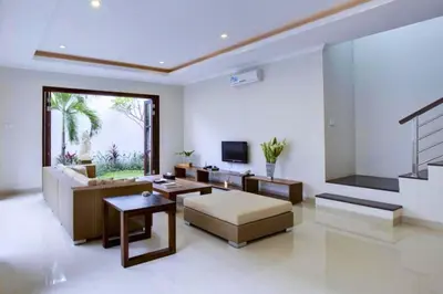 a living room with a couch and a television at Entire 3 BR Private Pool Villa in Seminyak