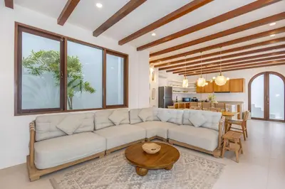 a living room with a couch and a table at Casa Pelagos in Kerobokan