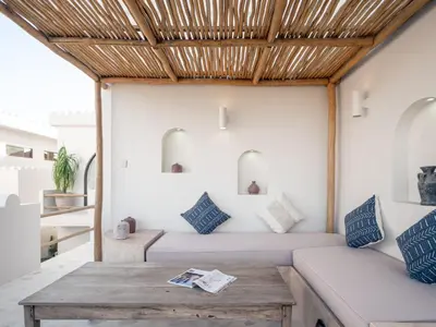 a room with a bed and a table at Casa Pelagos in Kerobokan