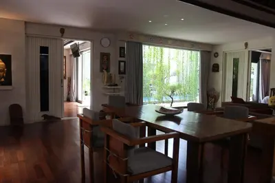 a living room with a wooden table and chairs at Vlad Bali Villa in Jimbaran
