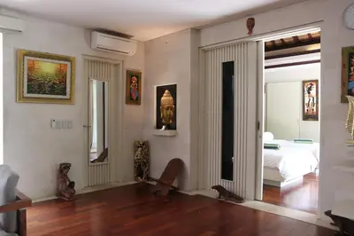 a room with a bedroom with a bed and a mirror at Vlad Bali Villa in Jimbaran