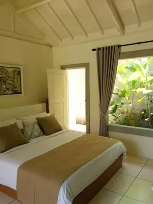 a bedroom with a large bed and a window at Villa Viona 4 in Seminyak