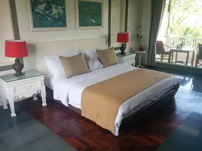 a bedroom with a bed with two tables and two lamps at Villa Viona 4 in Seminyak