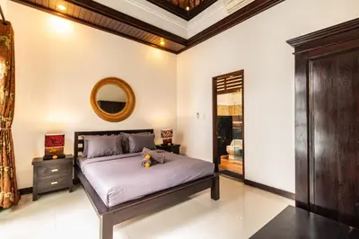 a bedroom with a bed and a mirror at PROMO Uniquely Styled Spacious 3bd Villa in Kerobokan