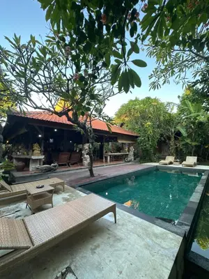 a swimming pool in front of a house at Bali Telaga Hati Yoga Healing and Retreat Center Villa in Sanur