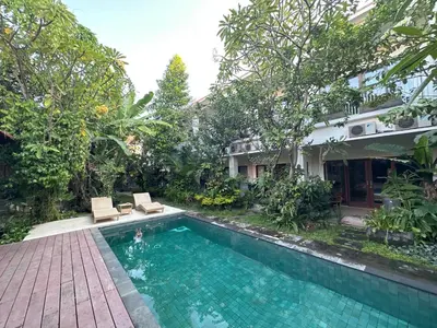 a swimming pool in front of a house at Bali Telaga Hati Yoga Healing and Retreat Center Villa in Sanur