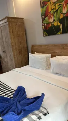 two beds in a room with a blue towel on them at Bali Telaga Hati Yoga Healing and Retreat Center Villa in Sanur