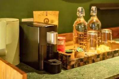 a counter with a coffee maker and bottles of alcohol at Romantic 1BR Private Pool Villa in Kerobokan