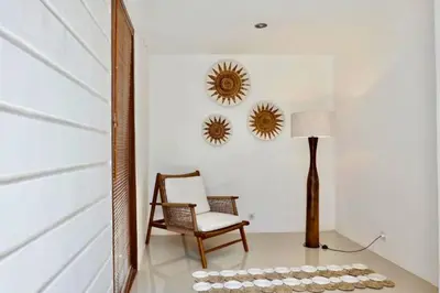 a room with a chair and a lamp and mirrors at Spacious 2 BR Private Pool Villa ZN108 in Seminyak
