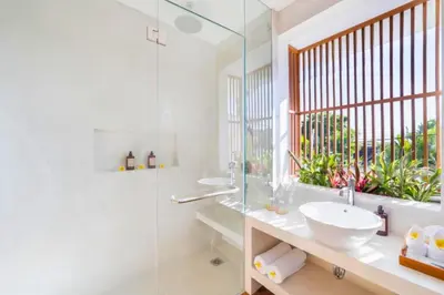 a bathroom with a glass shower and a sink at Garbera 2 BR Private Pool Villa in Canggu