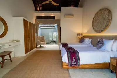 a bedroom with a large bed and a desk at Ocean Breeze Villa -4BR villa in Canggu in Canggu