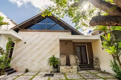 a house with a large window and a courtyard at Ocean Breeze Villa -4BR villa in Canggu in Canggu