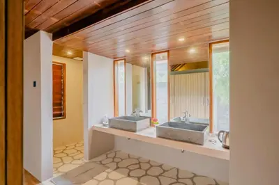 two sinks in a bathroom with two mirrors at One BR Bungalow Cozy Place in Canggu