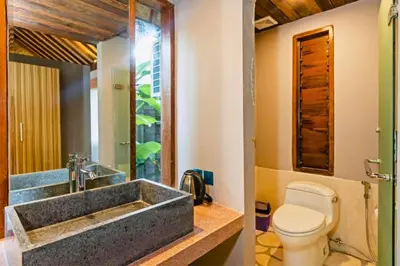 a bathroom with a sink and a toilet at One BR Bungalow Cozy Place in Canggu